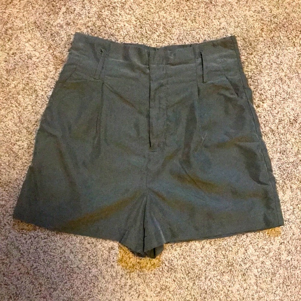 Green pleated shorts